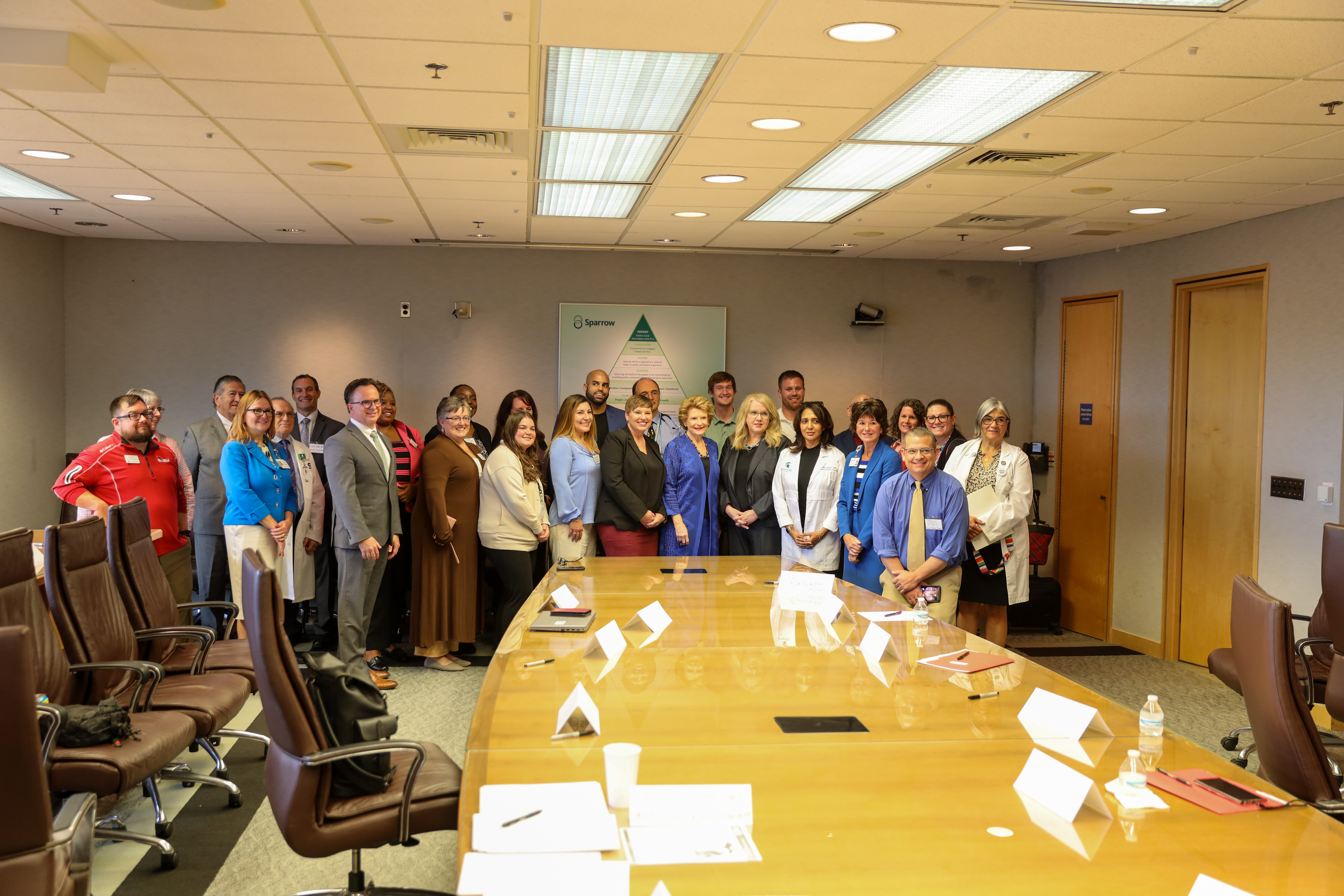 Michigan Senator Debbie Stabenow (center) with members of a Michigan Clinical Consultation & Care Program roundtable