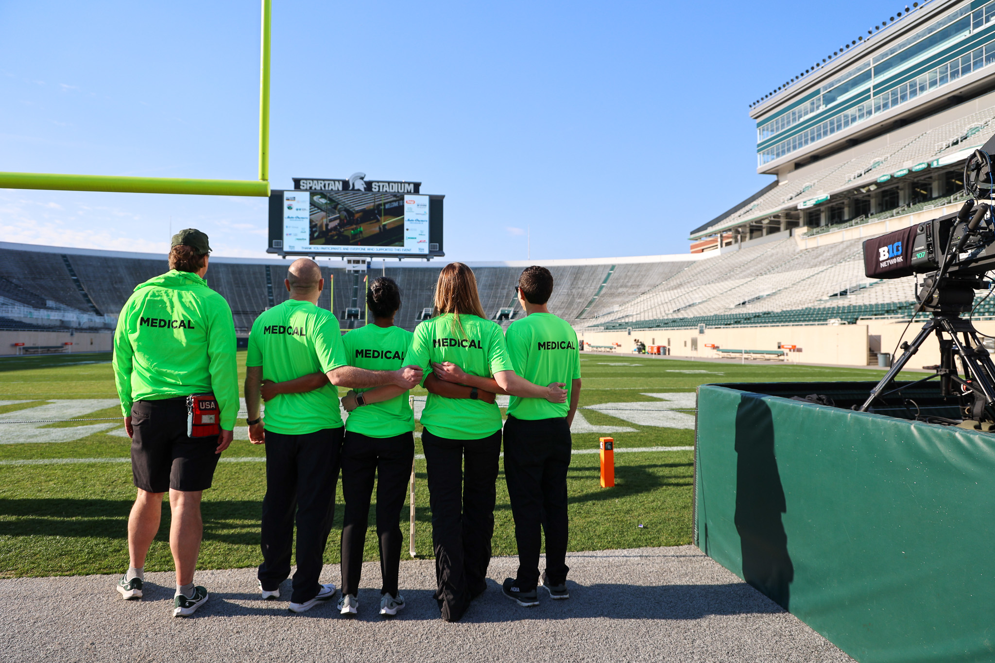 MSU Health Care Sports Medicine providers embracing inside Spartan Stadium
